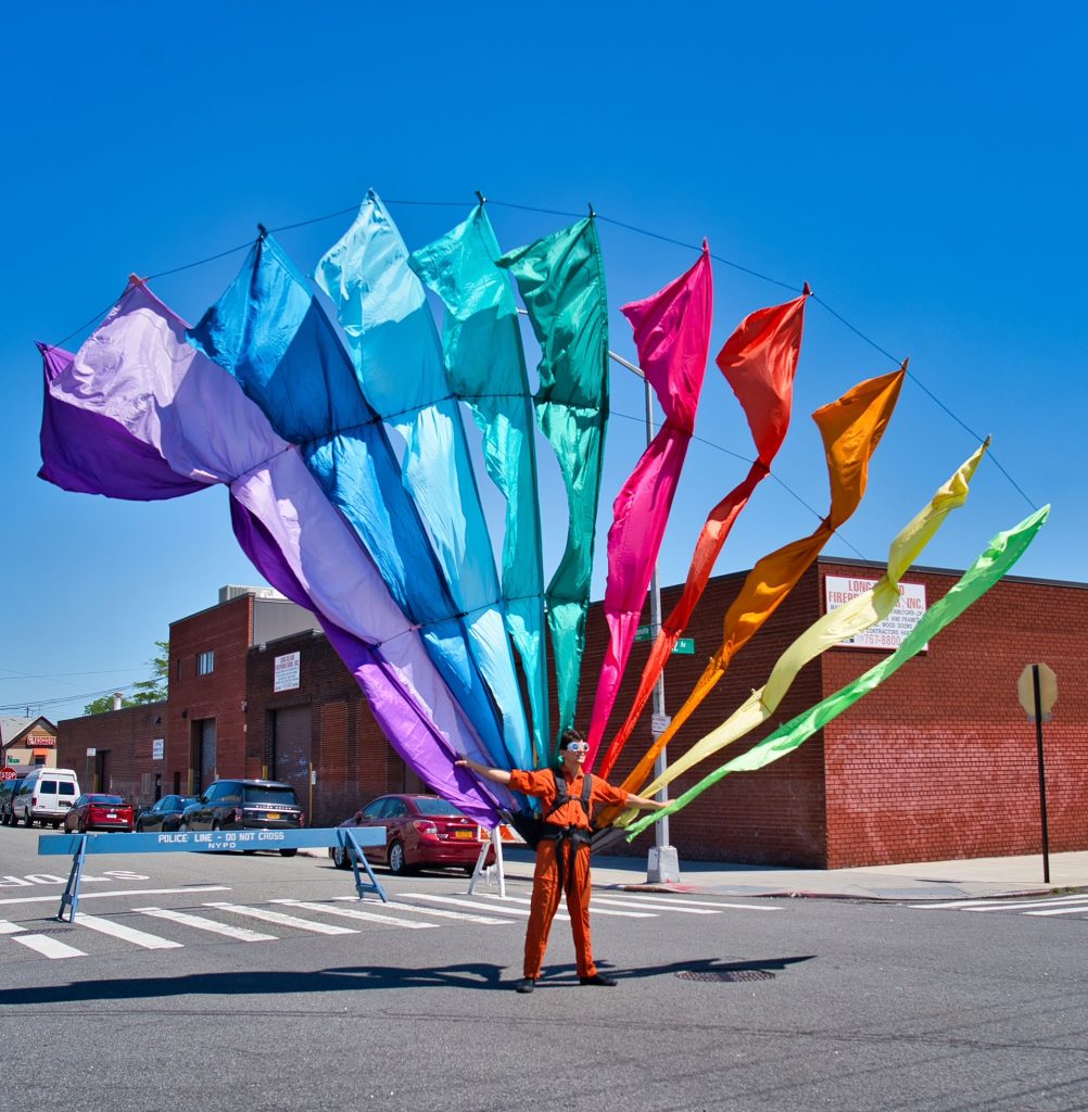 a person holding a large colorful kite